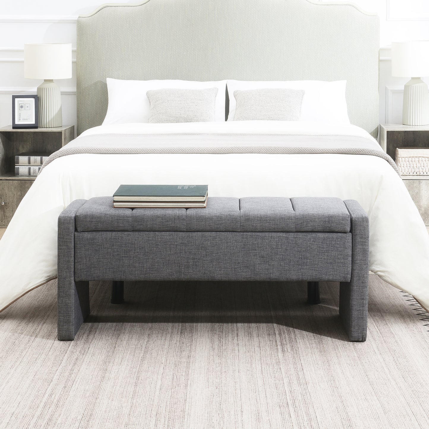 Tufted grey fabric storage bench with upholstered top providing bedroom seating and storage