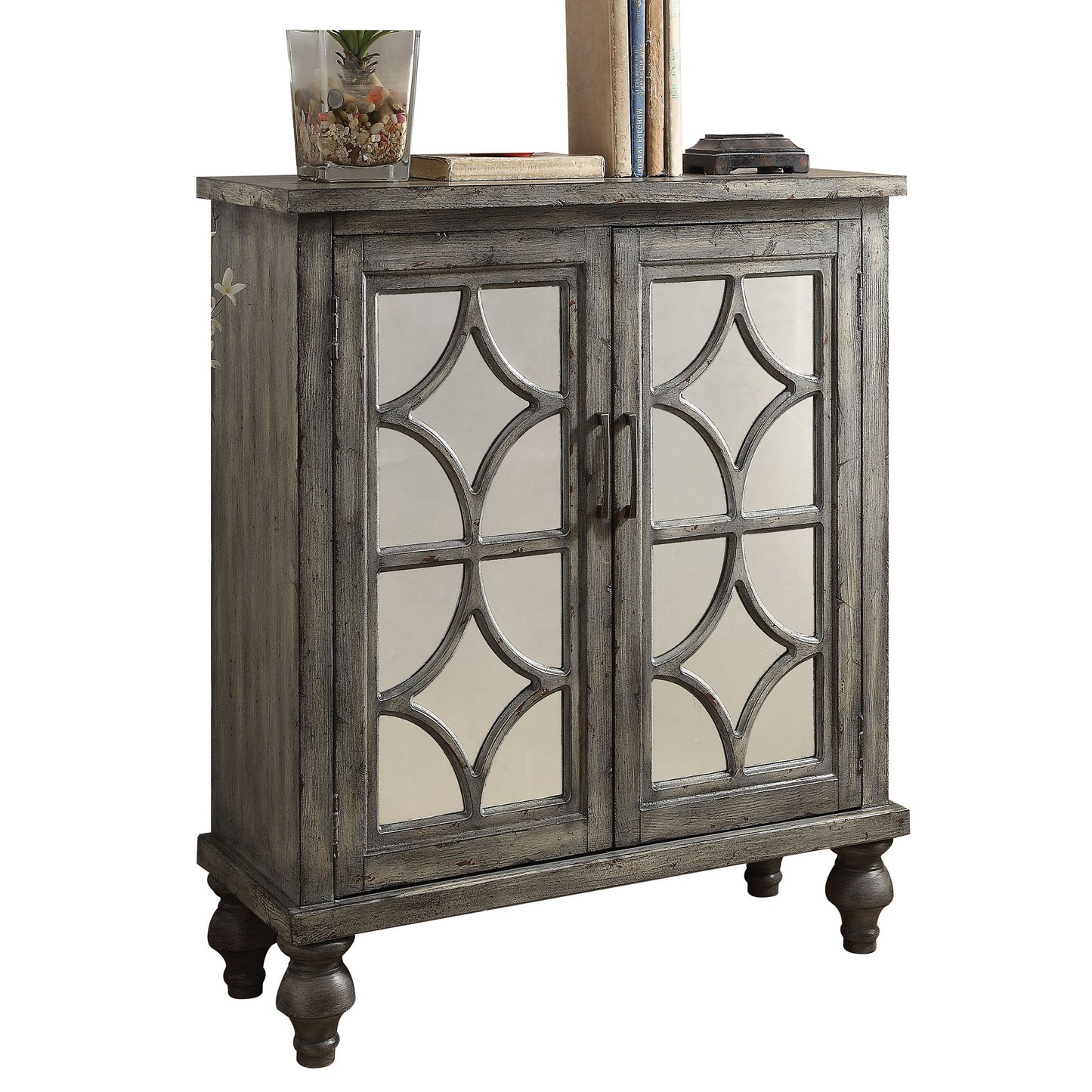 Distressed gray cabinet with mirrored quatrefoil glass doors and decorative carved legs