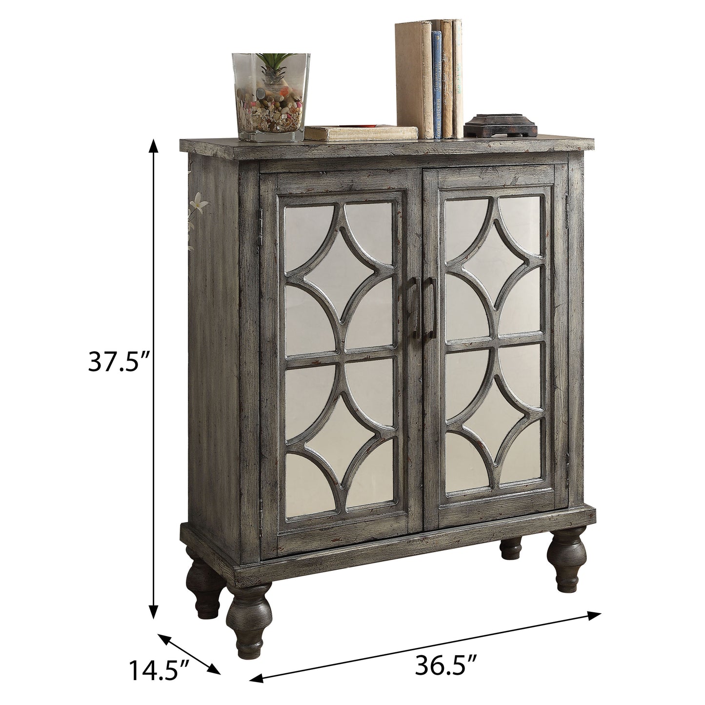 A distressed gray wood accent cabinet with mirrored doors featuring an intricate geometric design
