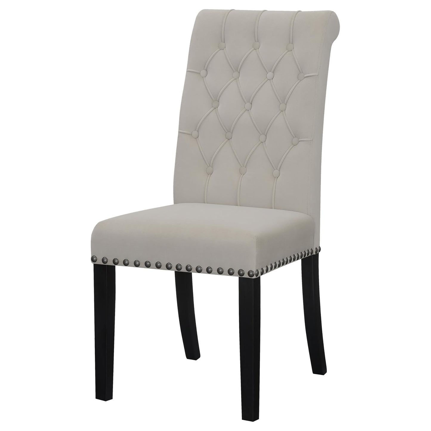 Tufted beige velvet dining chair with black wooden legs and silver nailhead trim