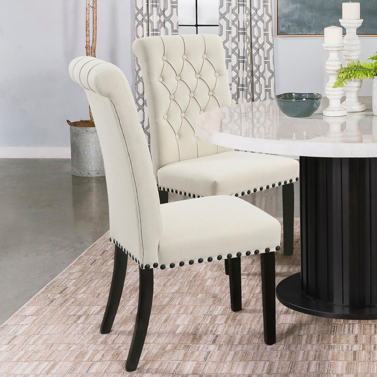 Tufted back ivory dining chair with nailhead trim and dark wood legs