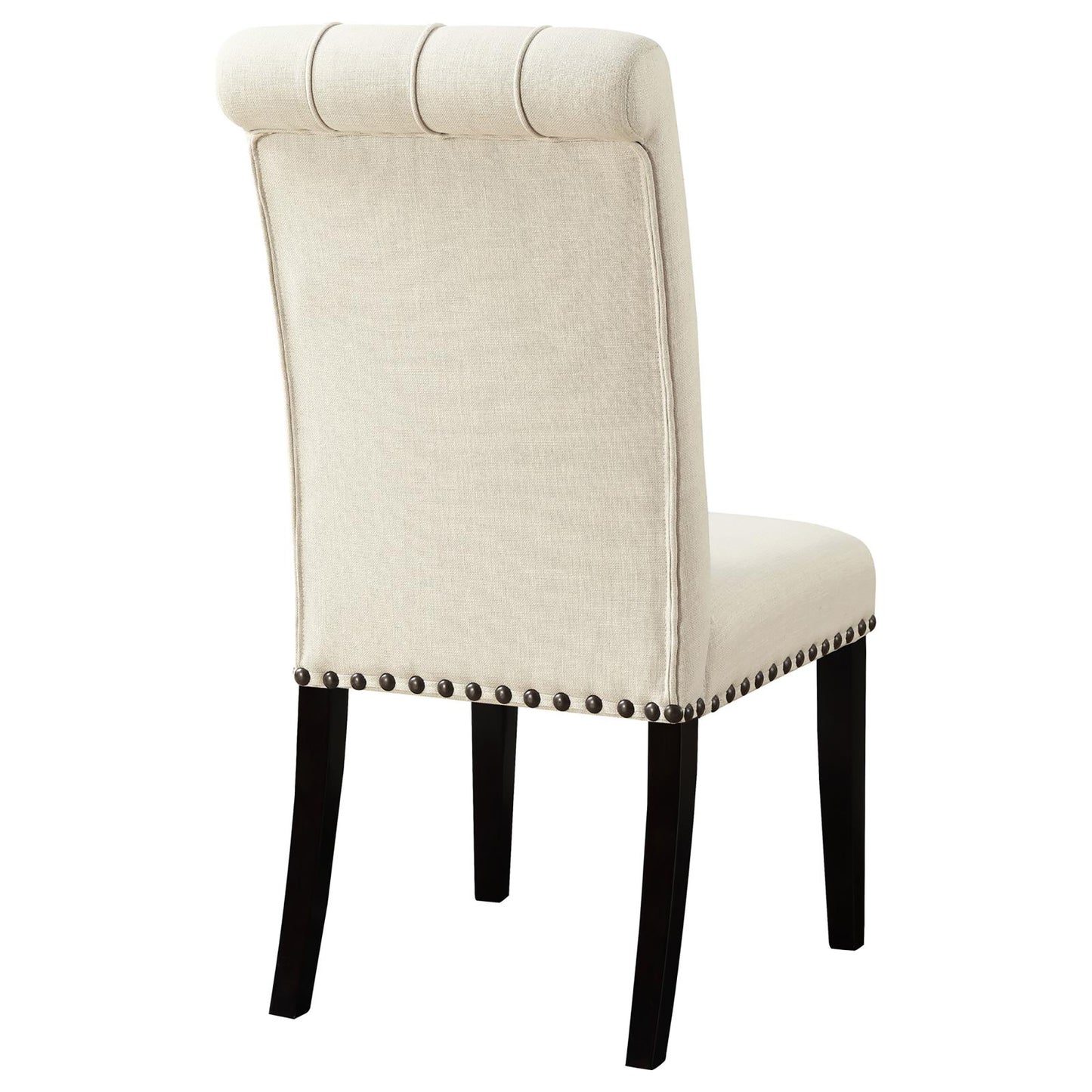 Tufted beige upholstered dining chair with dark wood legs and decorative nailhead trim