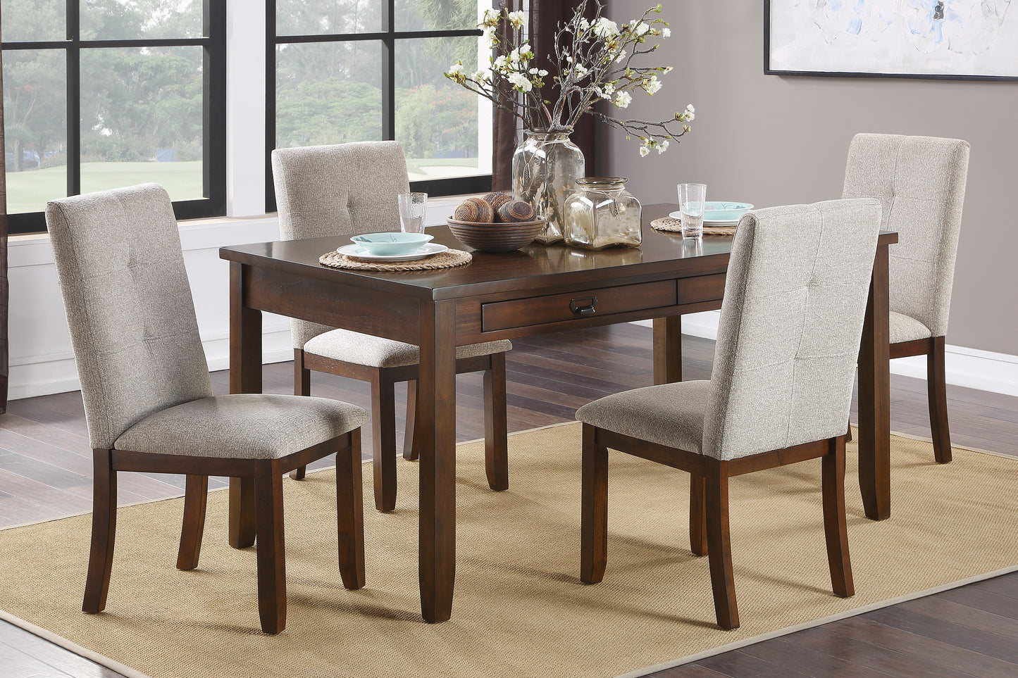 Dark wood dining table with four upholstered chairs ideal for intimate meals