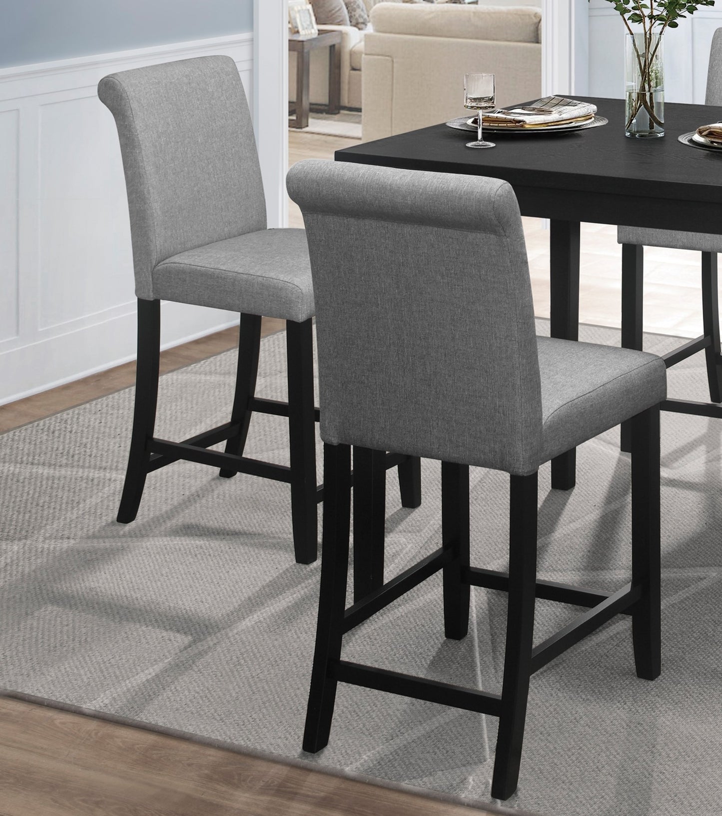 Gray upholstered bar stool with black wooden legs for modern kitchen counter seating