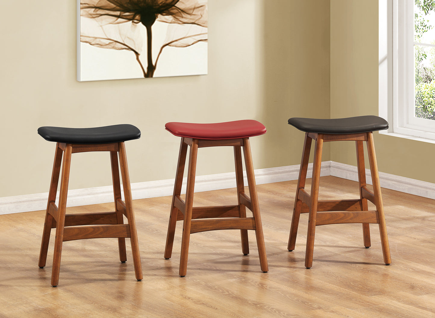 Three midcentury modern bar stools with wooden legs and black upholstered seats