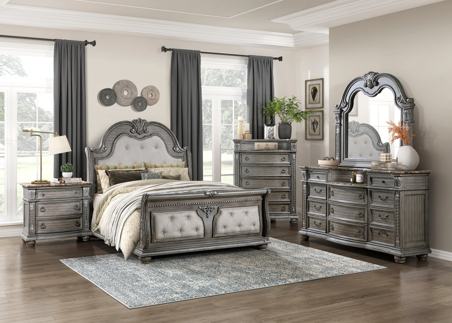 Ornate grey tufted queen bed frame with carved wood details and decorative pillows for master bedroom