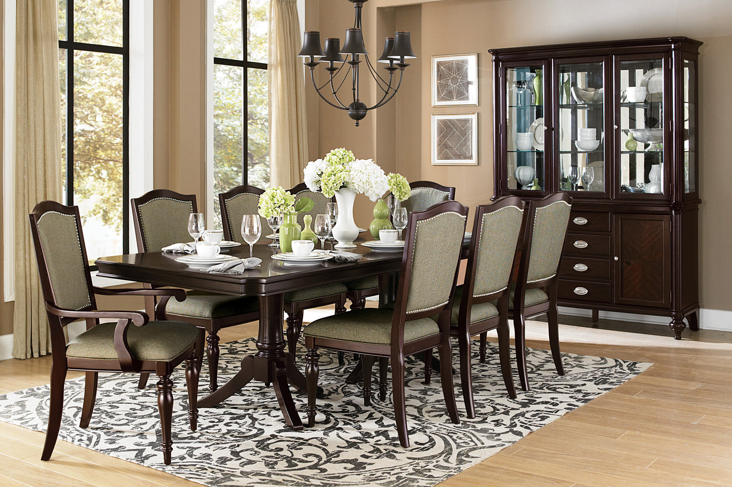 Dark wood dining table and chairs with upholstered seats and backs set for a meal