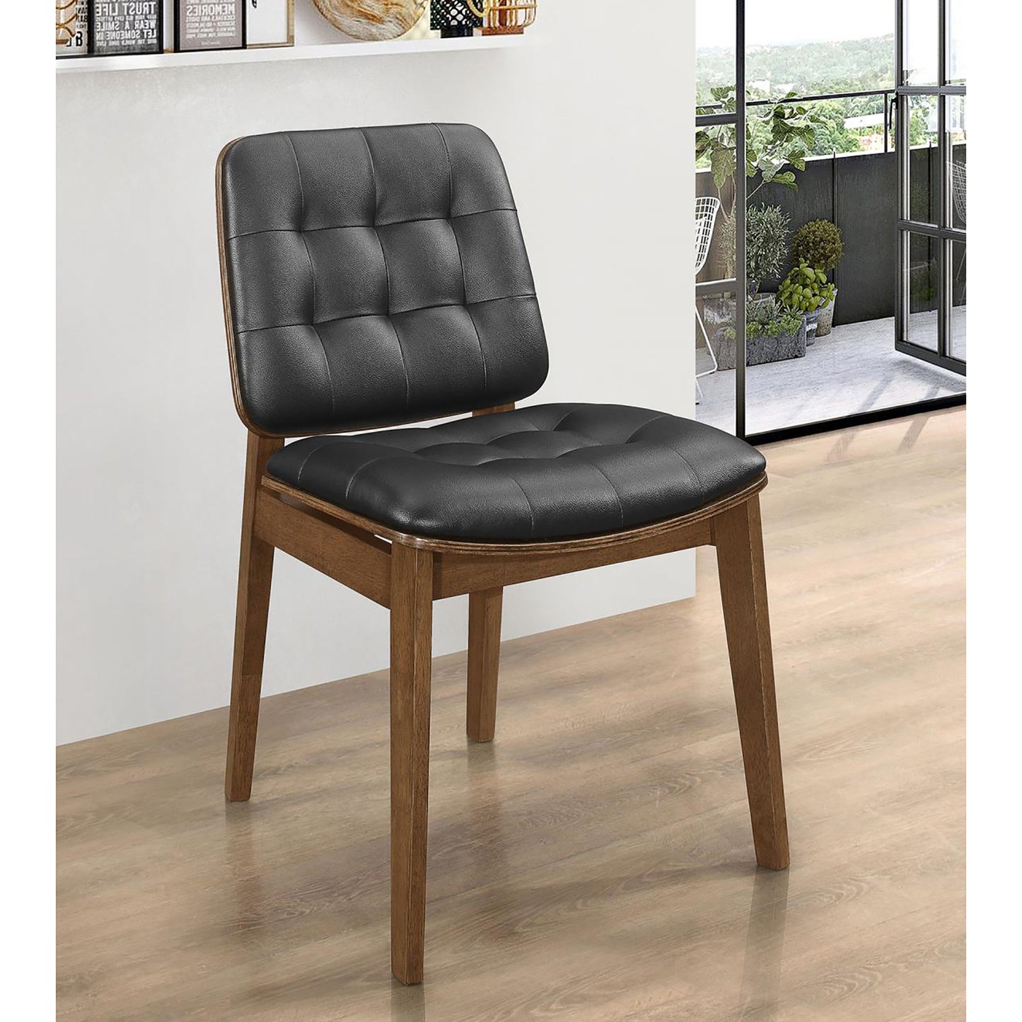 Tufted black leather dining chair with a natural wood frame modern design
