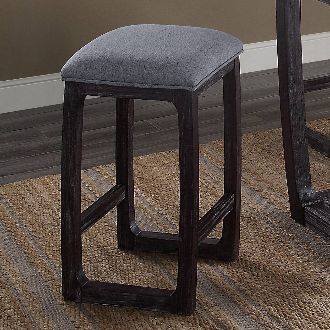 Gray upholstered counter stool with dark wood frame