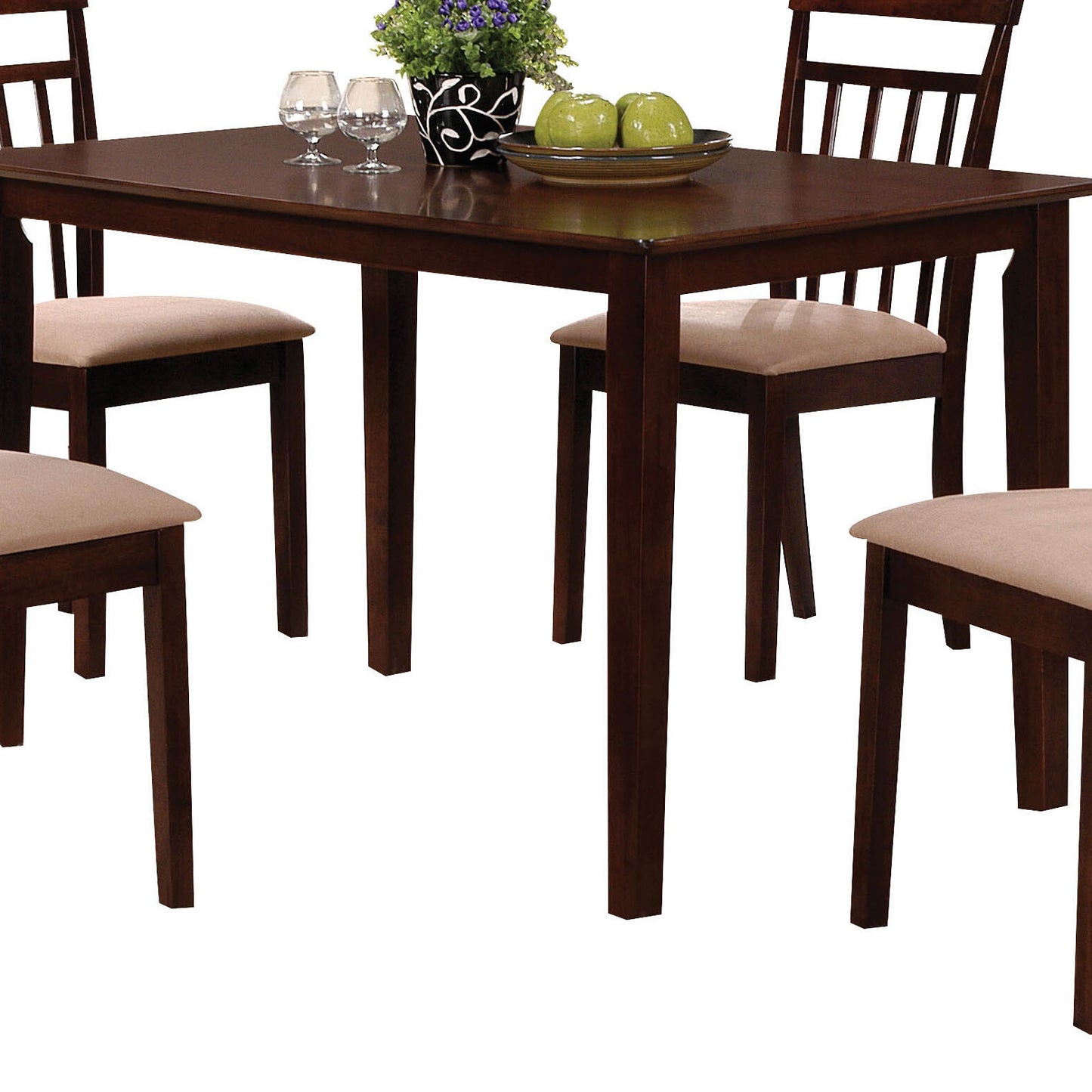 Dark brown dining table set with beige upholstered chairs and decorative fruit bowl