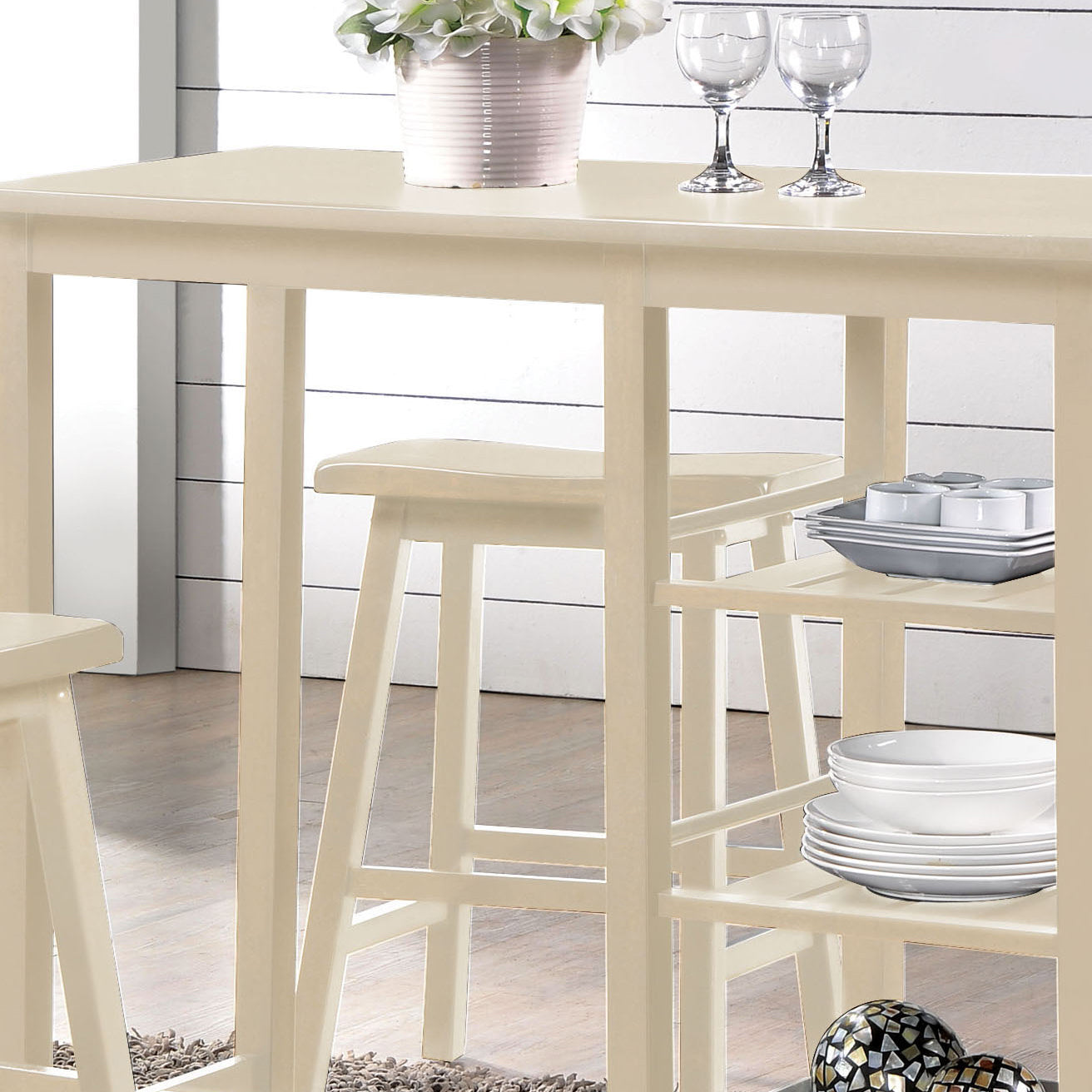 Cream finish bar table and stools with builtin shelves ideal for small kitchens