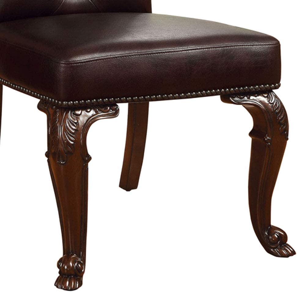 Dark brown faux leather chair seat with ornate carved dark wood legs