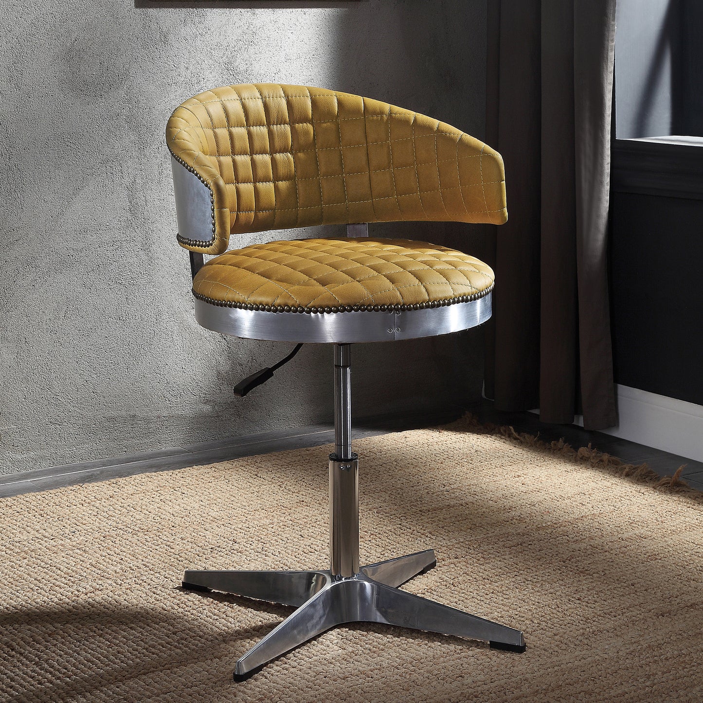Yellow quilted leather desk chair with brushed metal accents and chrome base