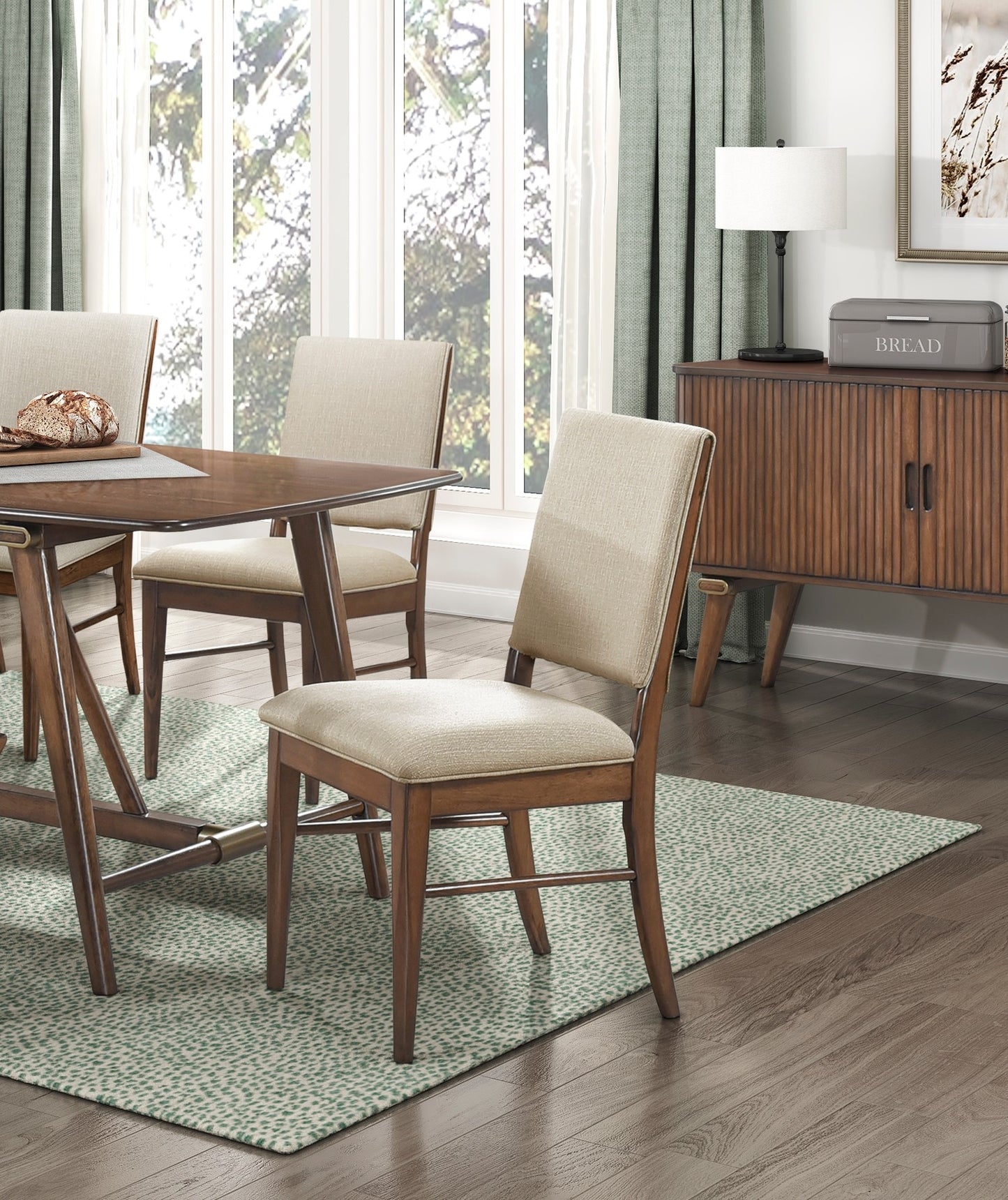 Upholstered dining chair with a wood frame in a neutral beige fabric