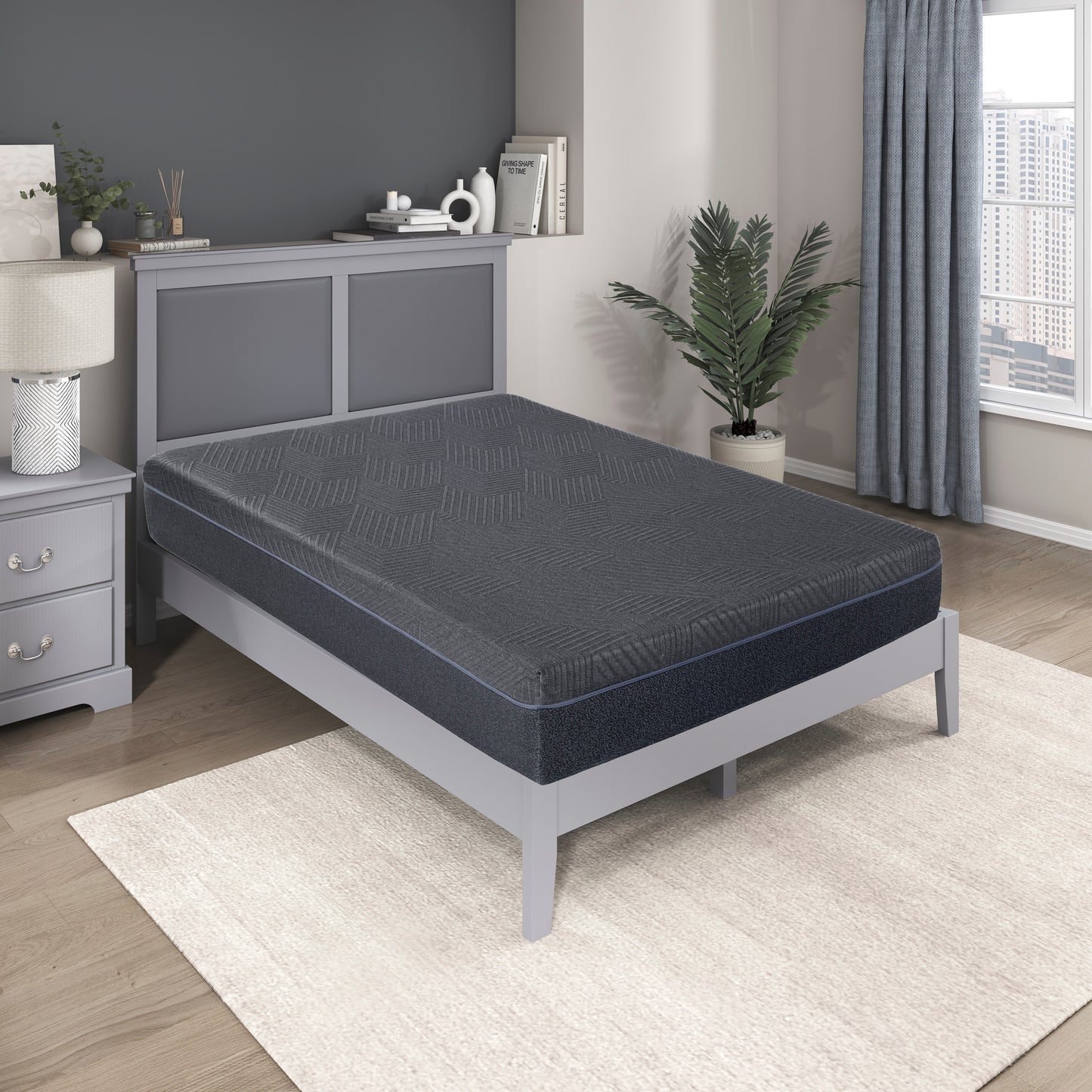 Dark gray queen mattress with textured pattern and blue trim on a grey bed frame