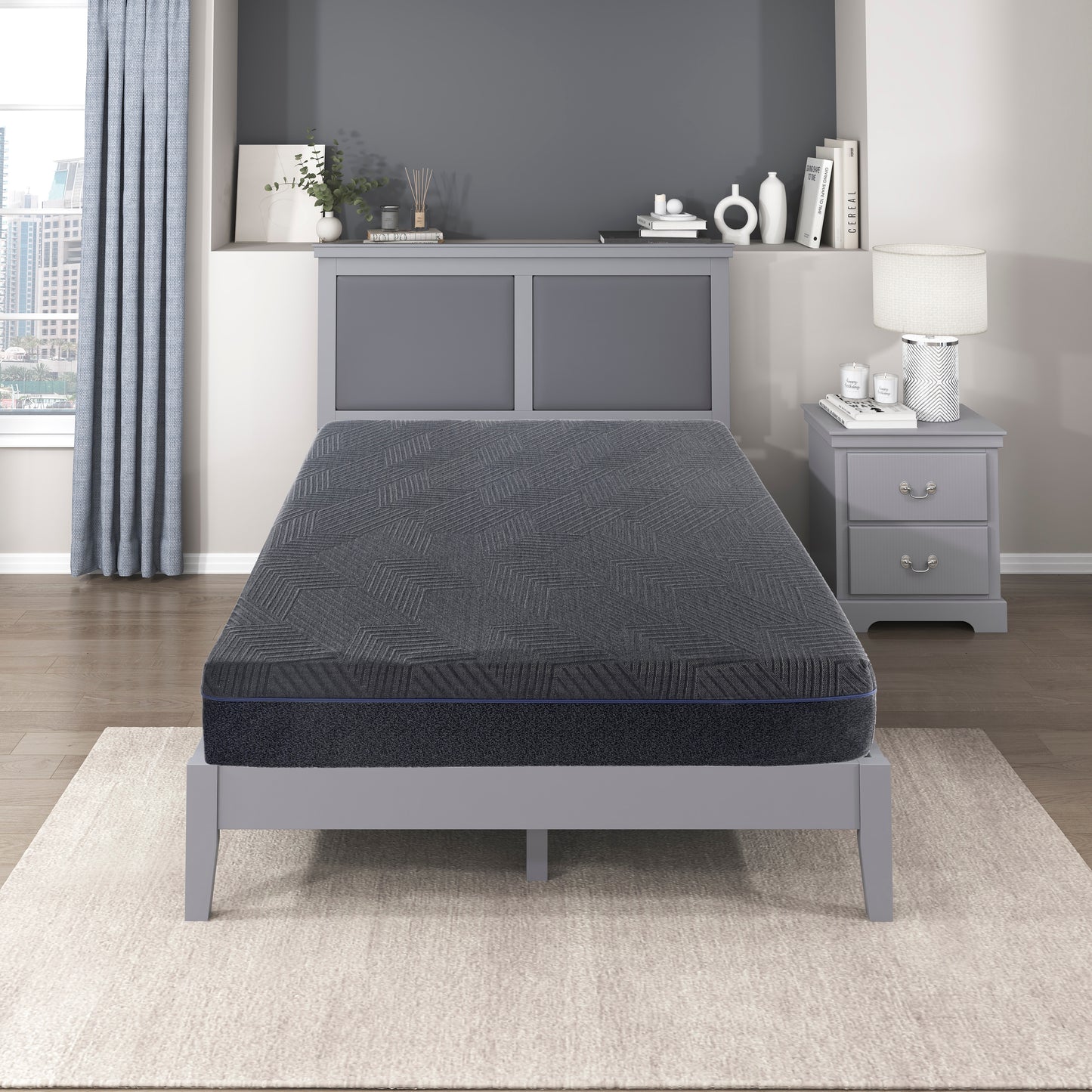 Dark grey queen mattress with geometric pattern and blue trim on a grey bed frame