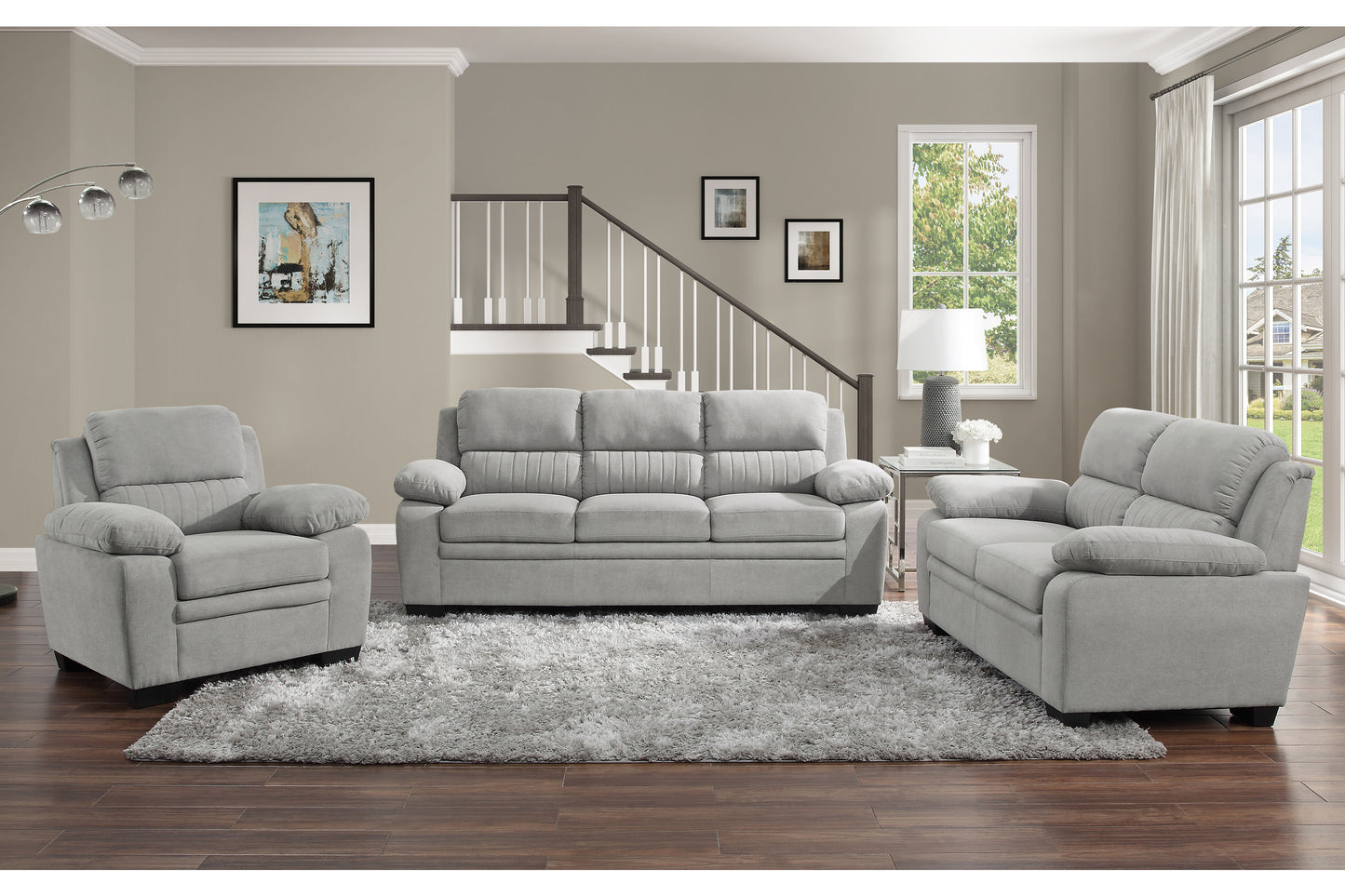 Plush gray recliner chair with padded arms and tufted back cushions