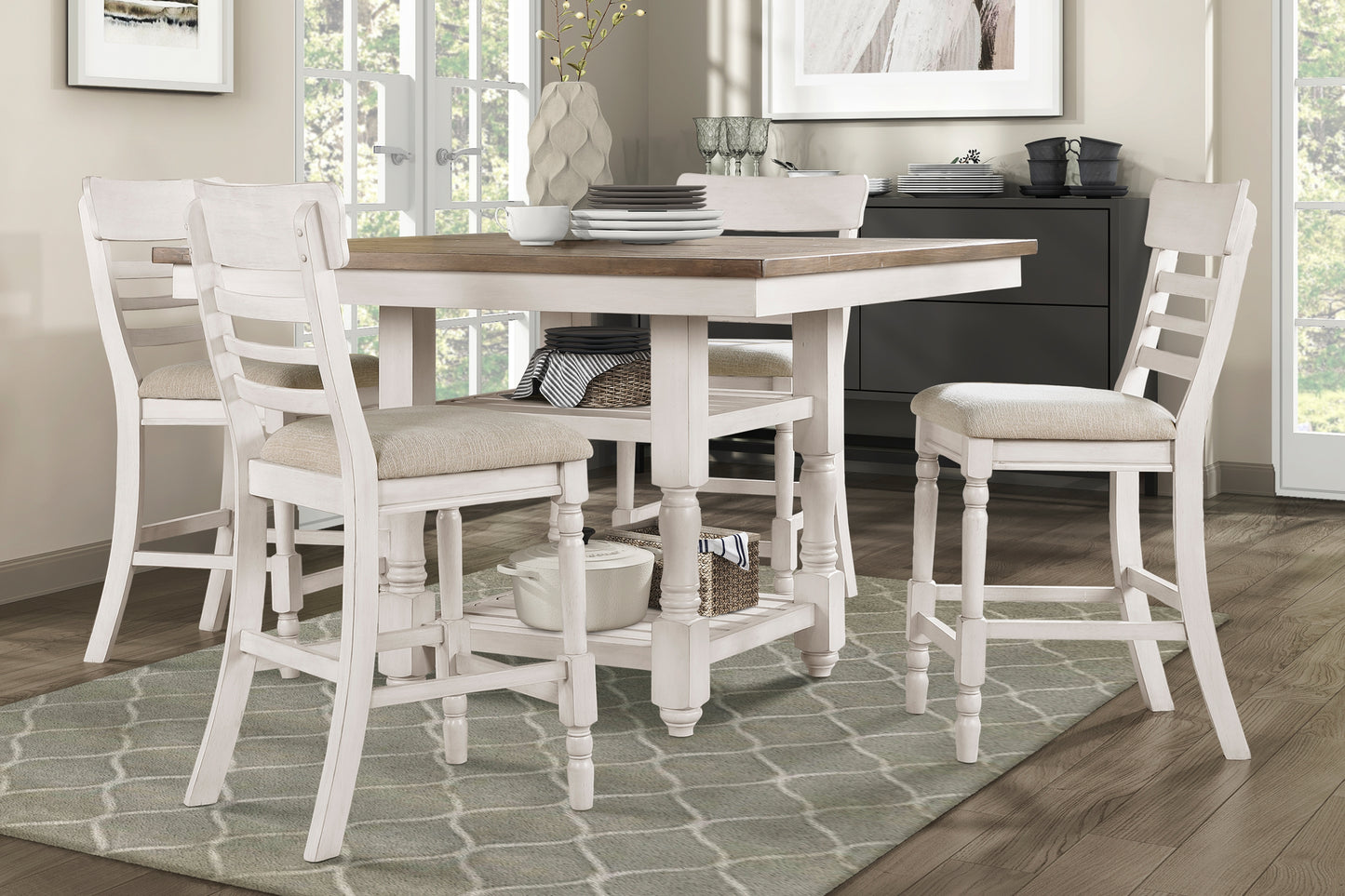 White distressed wood counter height table with upholstered stools for dining area