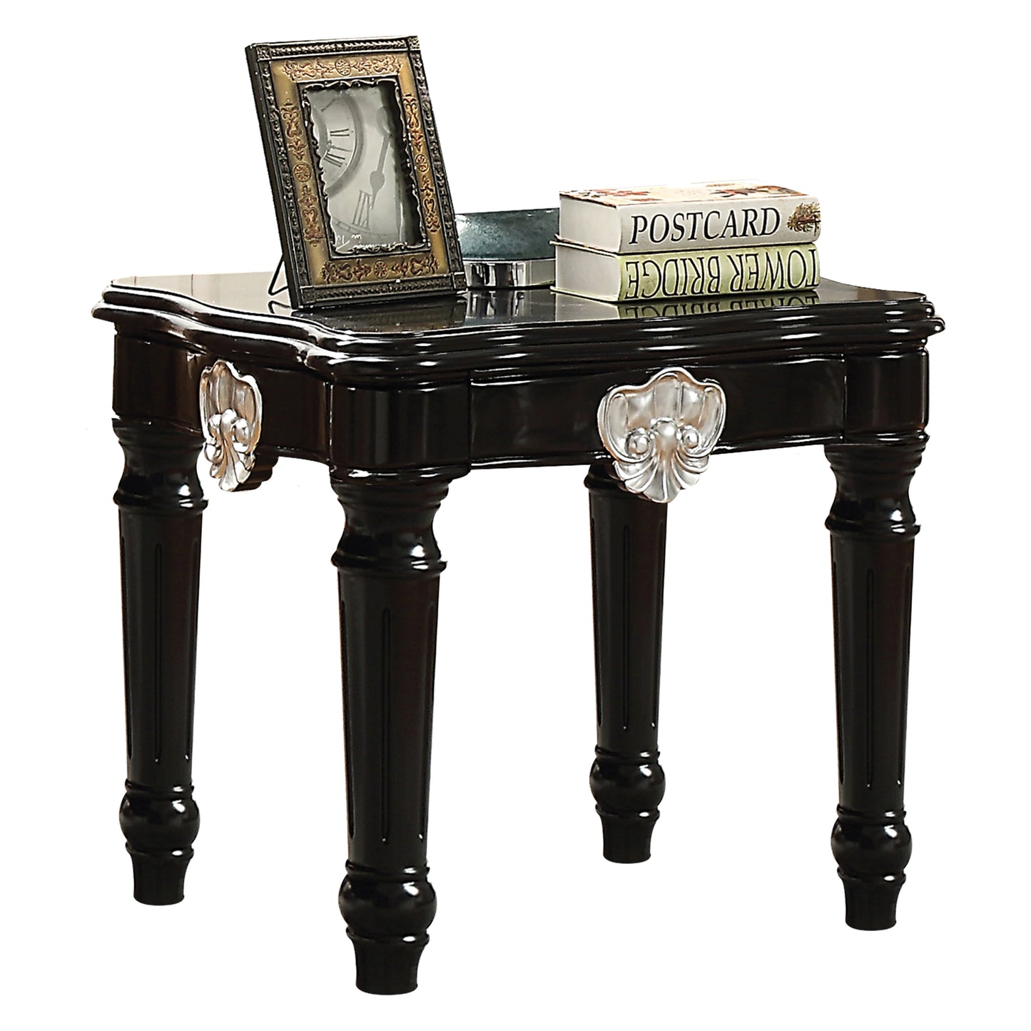 Ornate black end table with carved silver accents and a decorative clock