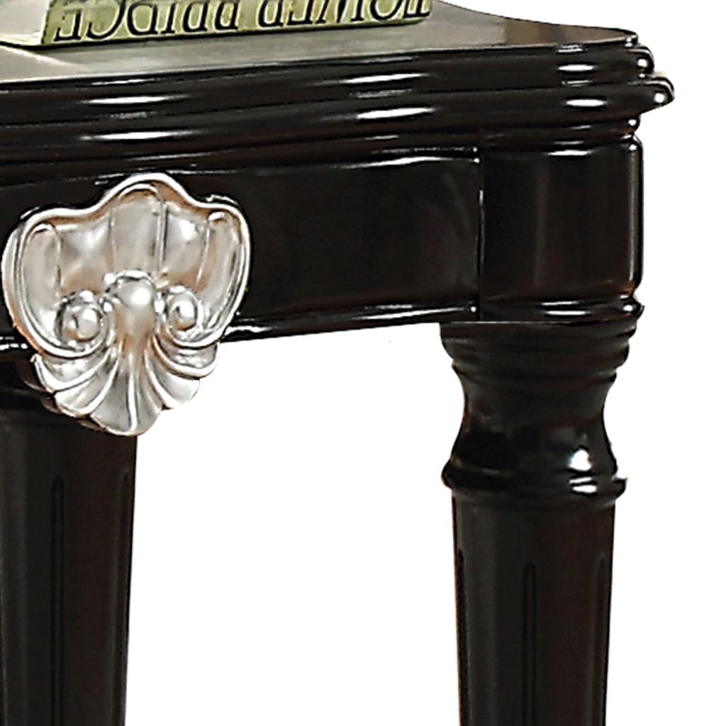 Black lacquered side table with ornate silver shell drawer pull detail