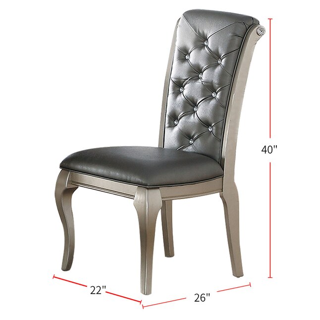 Silver upholstered dining chair with crystal tufting and carved wooden legs