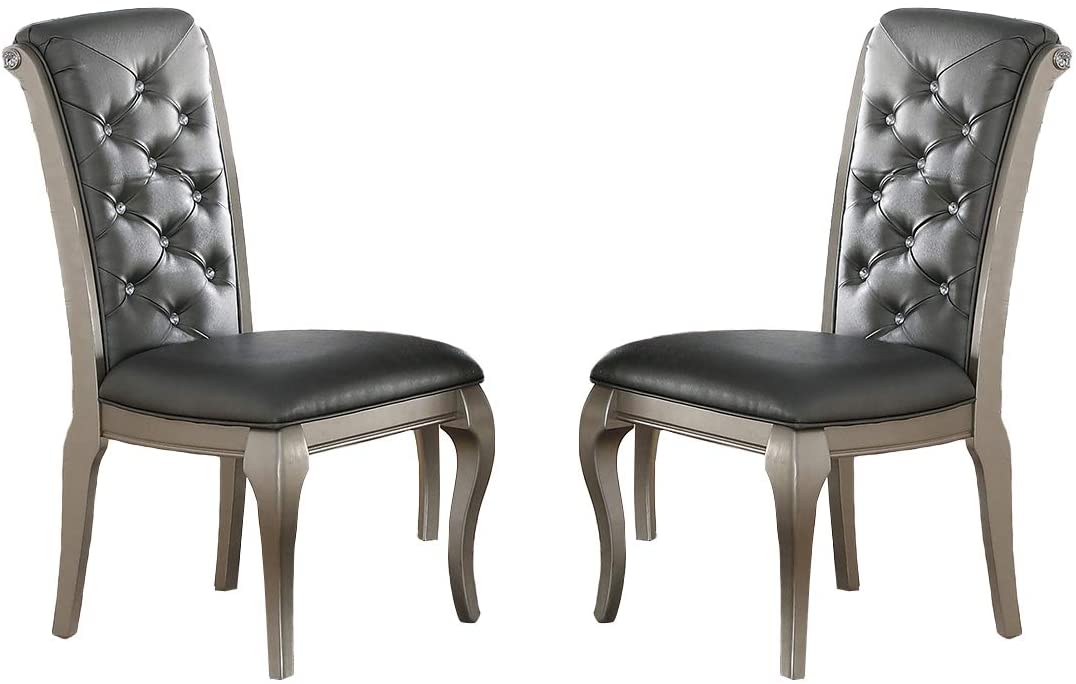 Two tufted grey faux leather dining chairs with silver wood frames and crystal accents