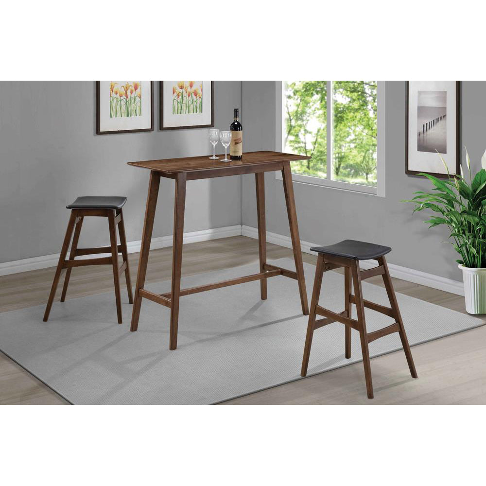 Wooden bar table with two dark grey stools and wine glasses