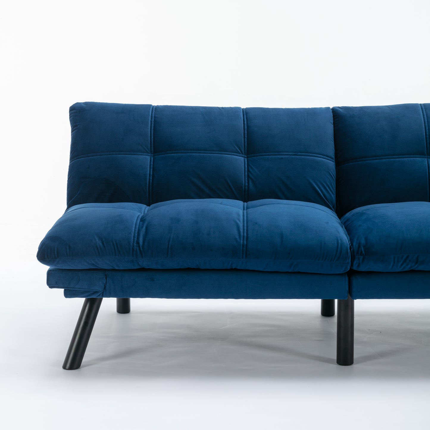 Deep blue velvet sofa with tufted back and square seat cushions on black legs