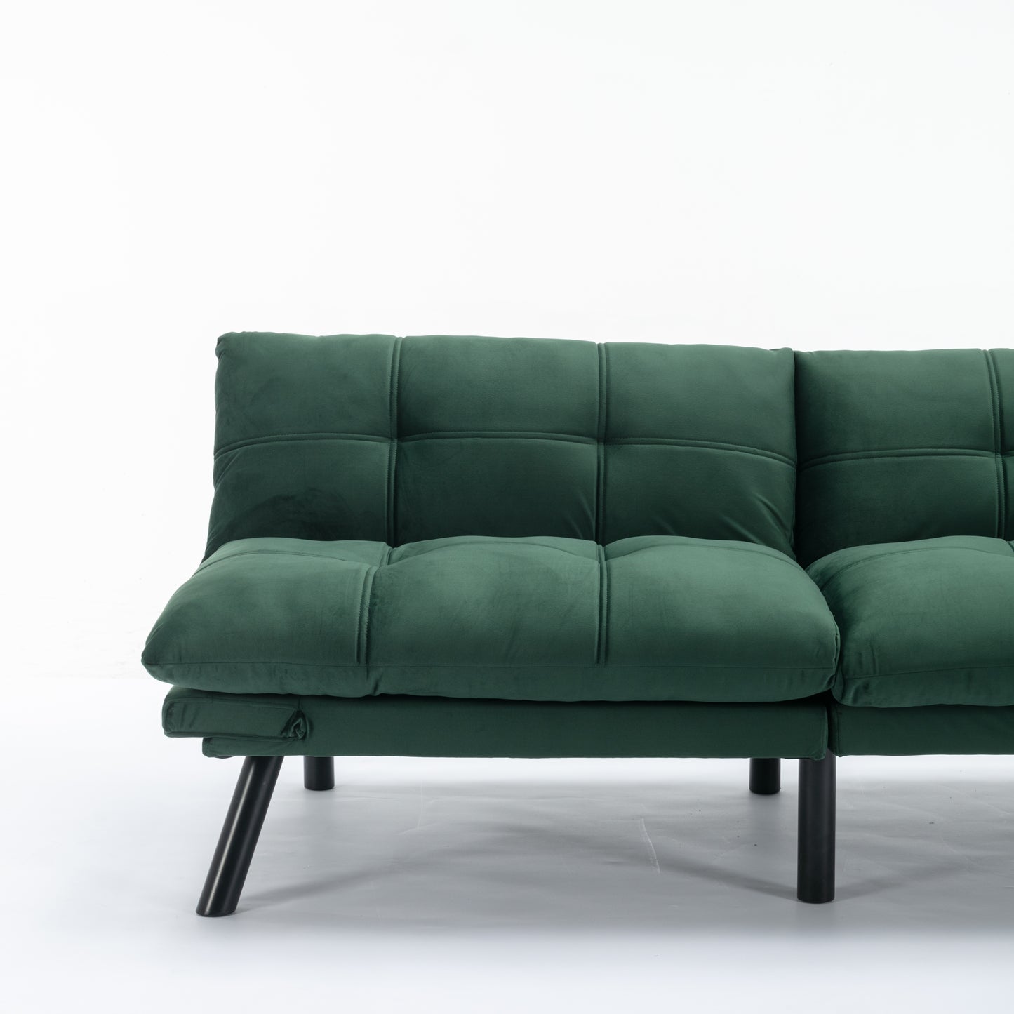Deep emerald velvet sofa with tufted cushions and black metal legs perfect for modern living rooms