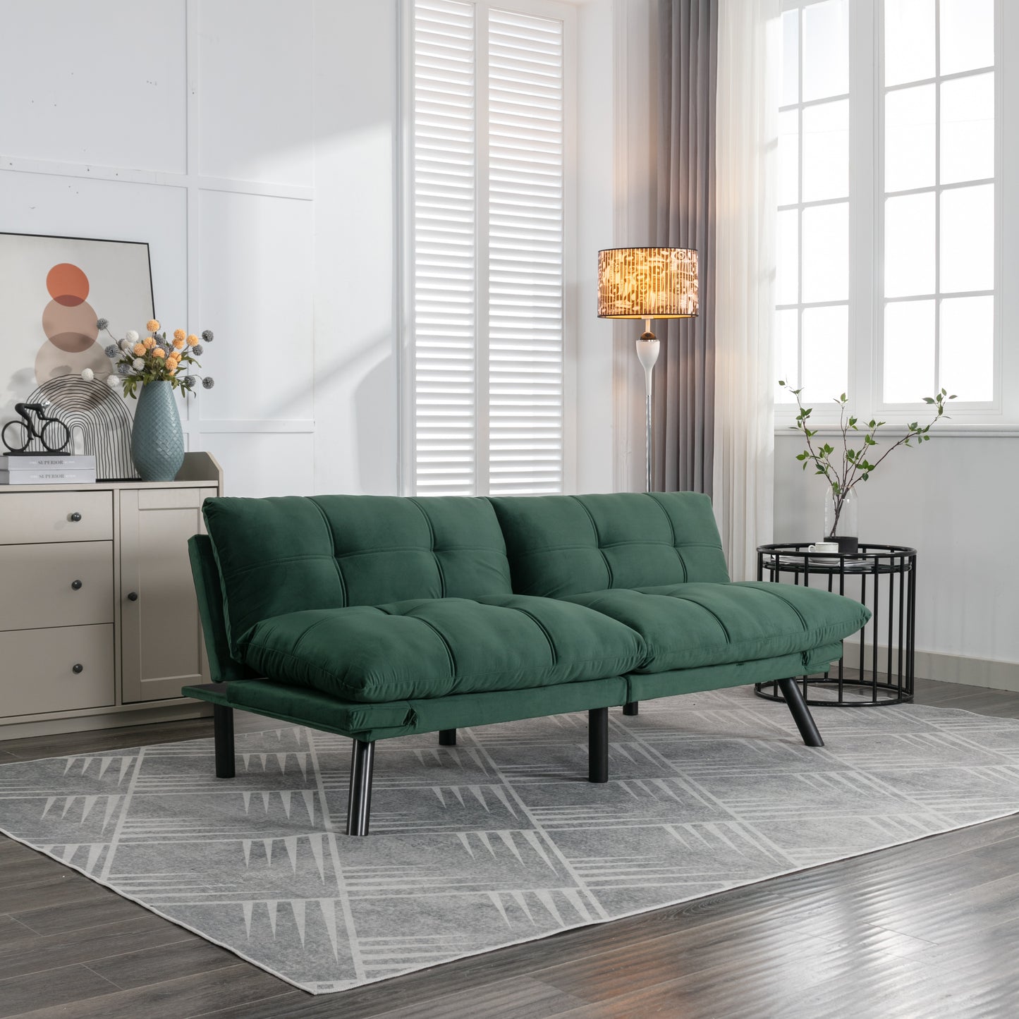 Deep green velvet futon sofa with tufted cushions on modern chrome legs