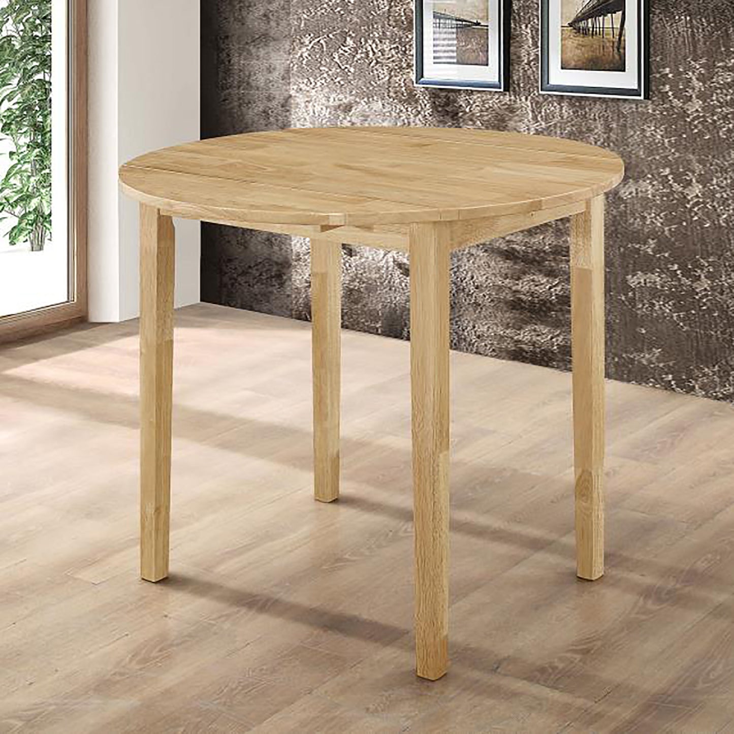 Round light wood dining table with four tapered legs perfect for small kitchens