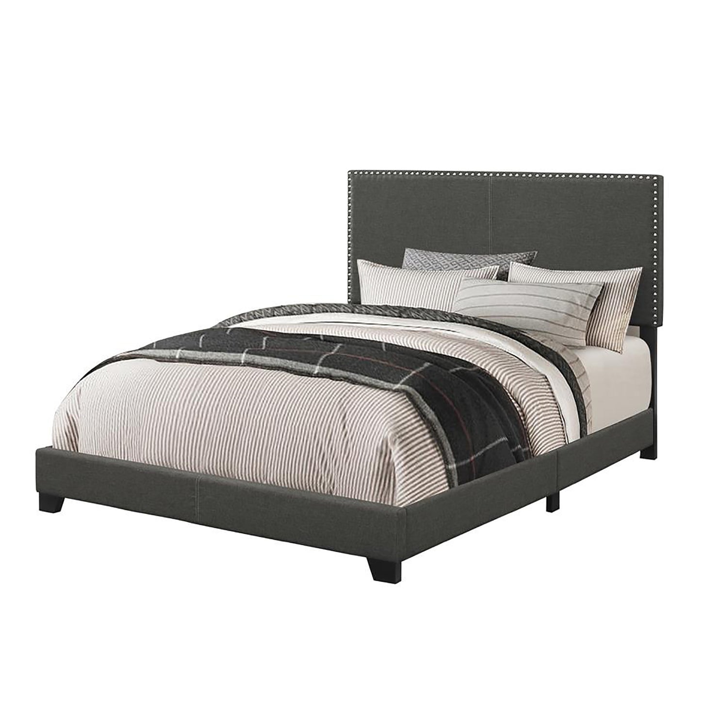 Dark grey upholstered king bed with silver nailhead trim and striped bedding