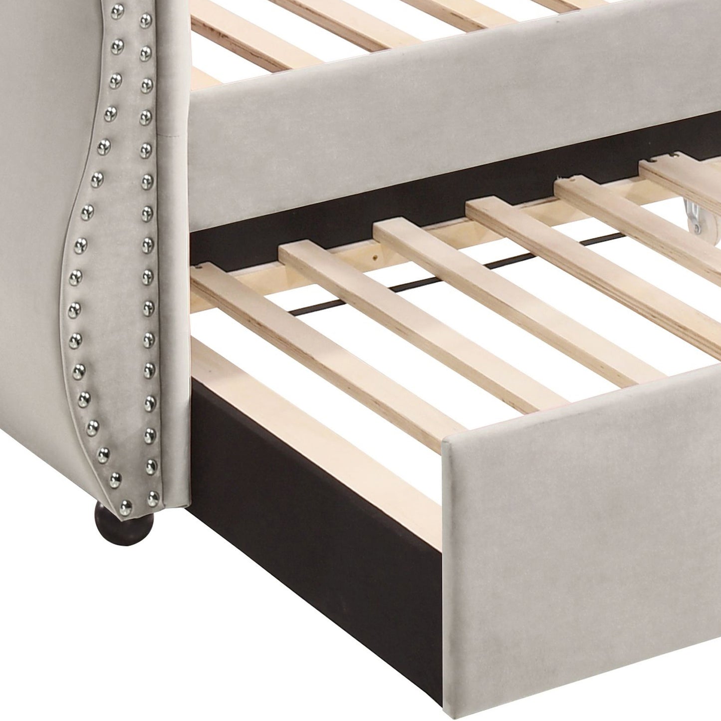 Light gray velvet daybed with studded trim open slat support