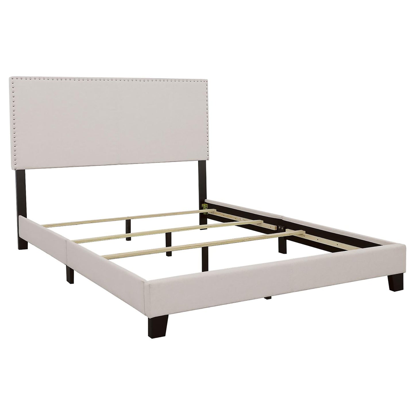 Upholstered bed frame with nailhead trim headboard and dark wood legs