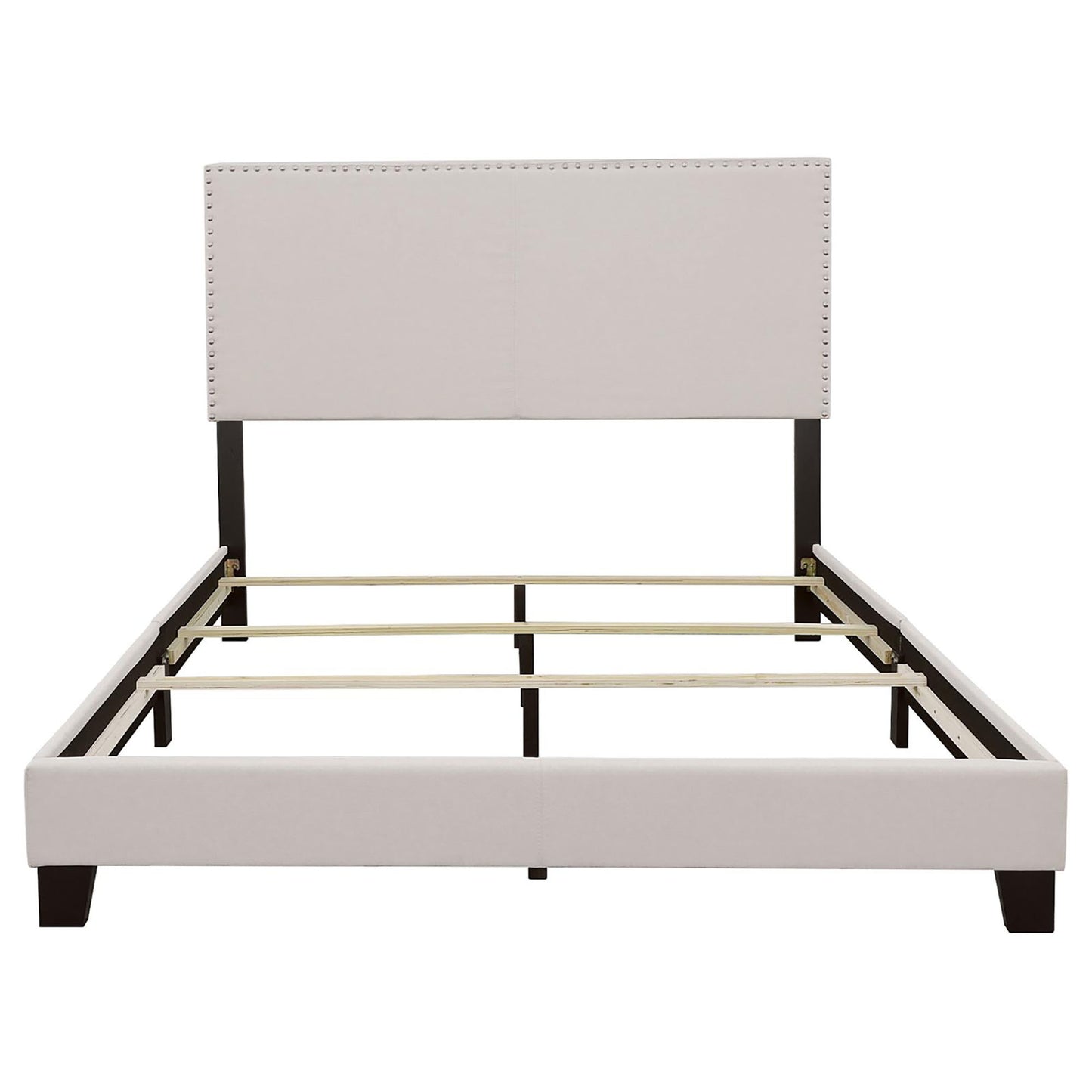 Upholstered bed frame with nailhead trim headboard and dark wood legs