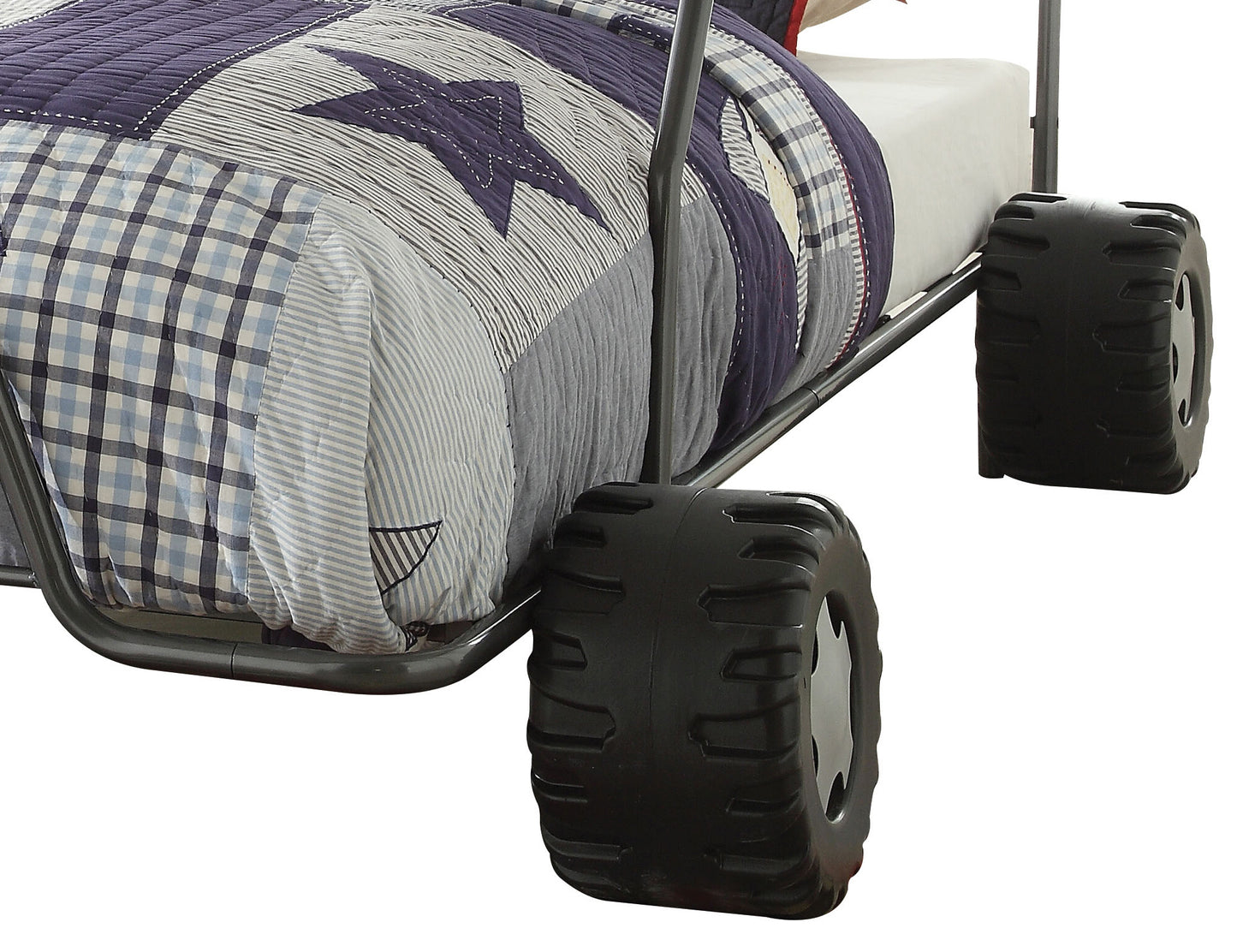 Blue and white starpatterned quilt on a twin bed frame with tirelike wheels