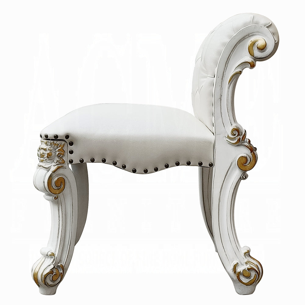 White tufted vanity stool with ornate gold carved legs and antique brass nailhead trim