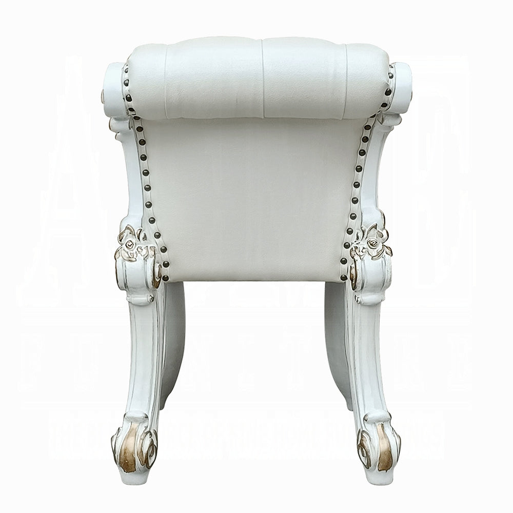 Elegant white tufted armchair with gold accents and silver nailhead trim