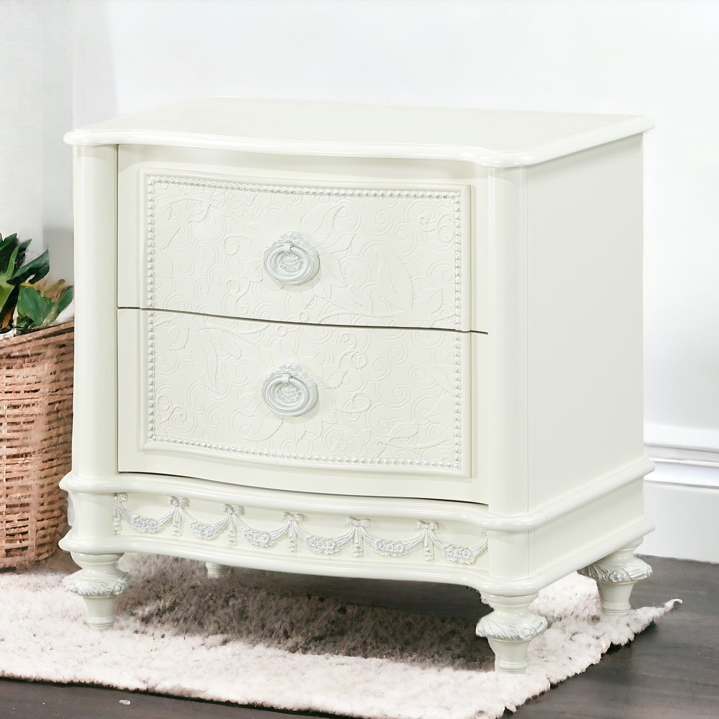 Ornate ivory bedside table with embossed floral design and ornate pulls