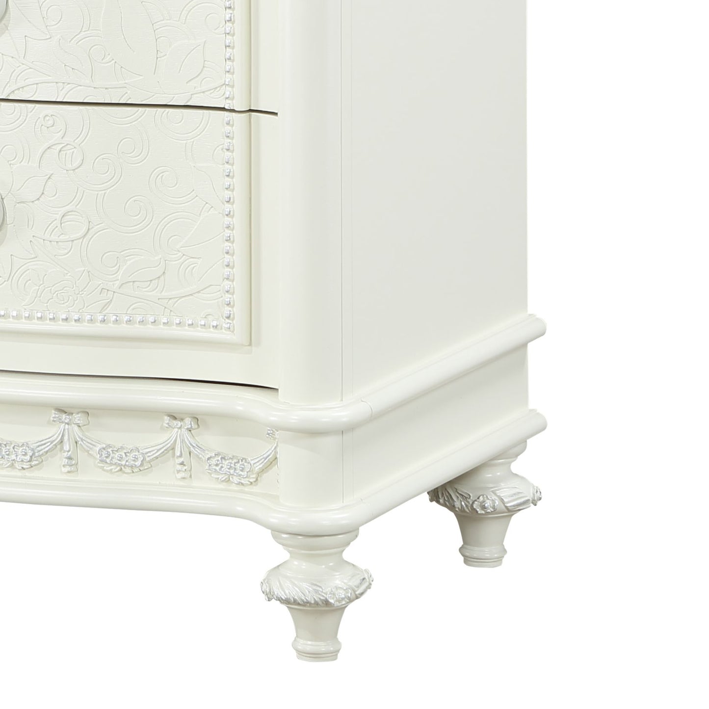 White ornate nightstand with carved floral accents and beaded trim