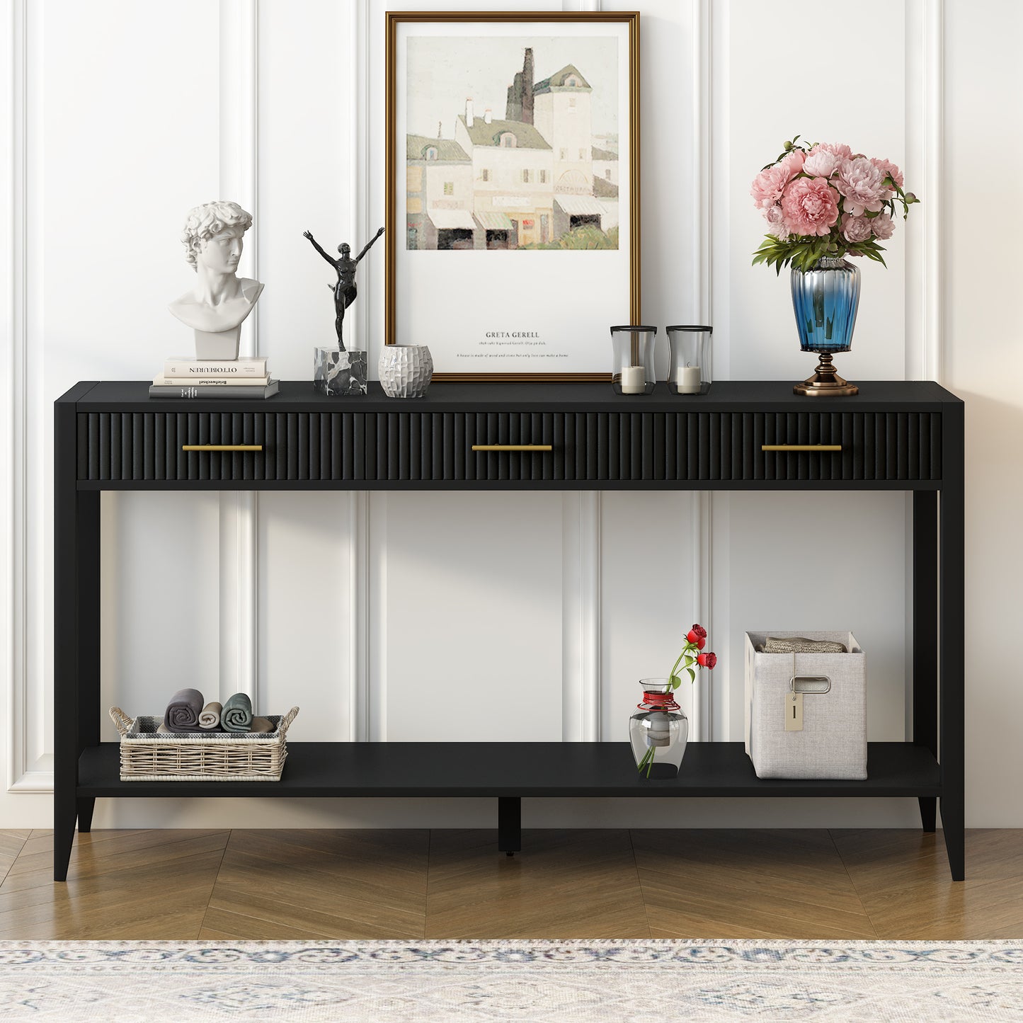 Black fluted console table with gold drawer pulls and decorative items