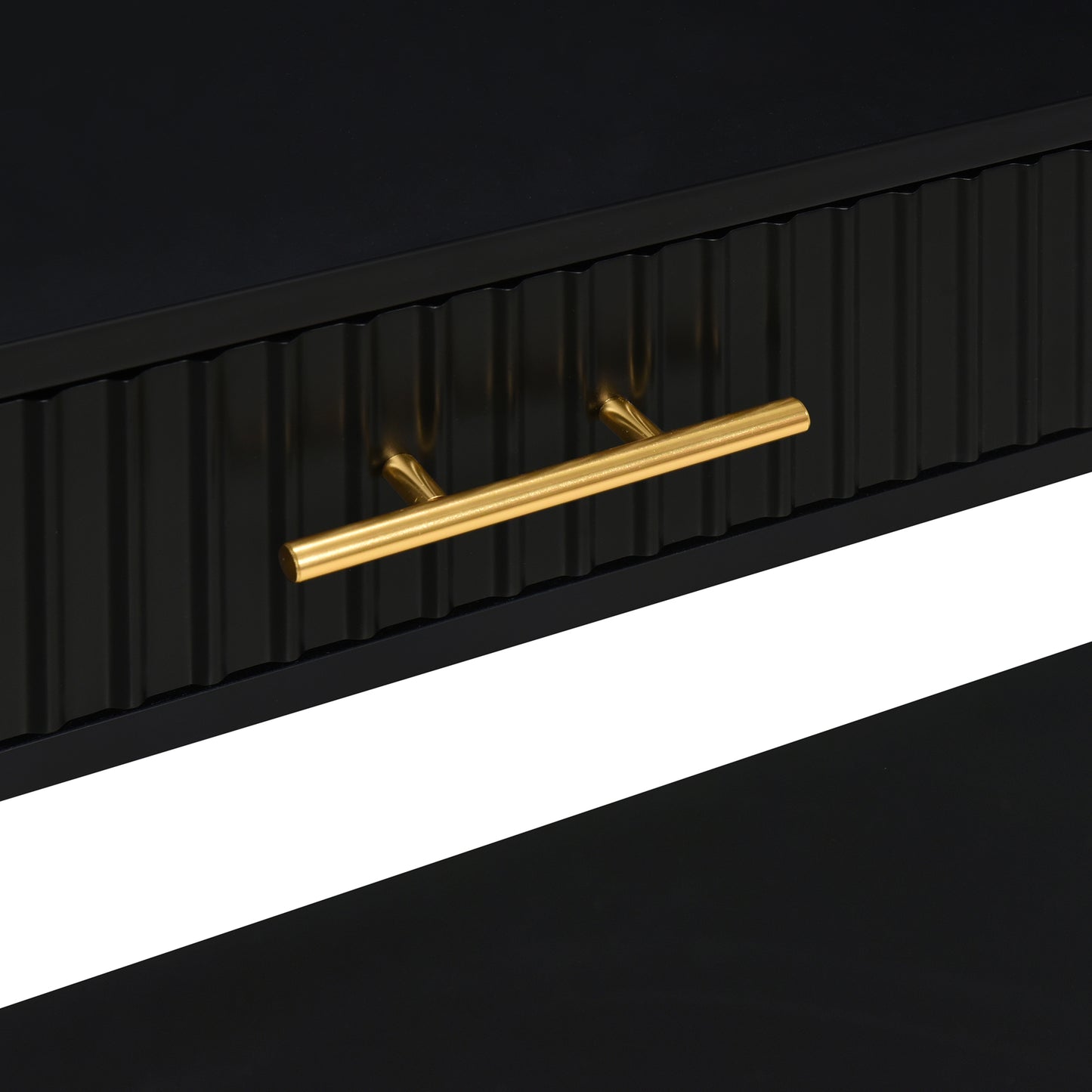 Black fluted drawer with gold bar pull on modern dresser