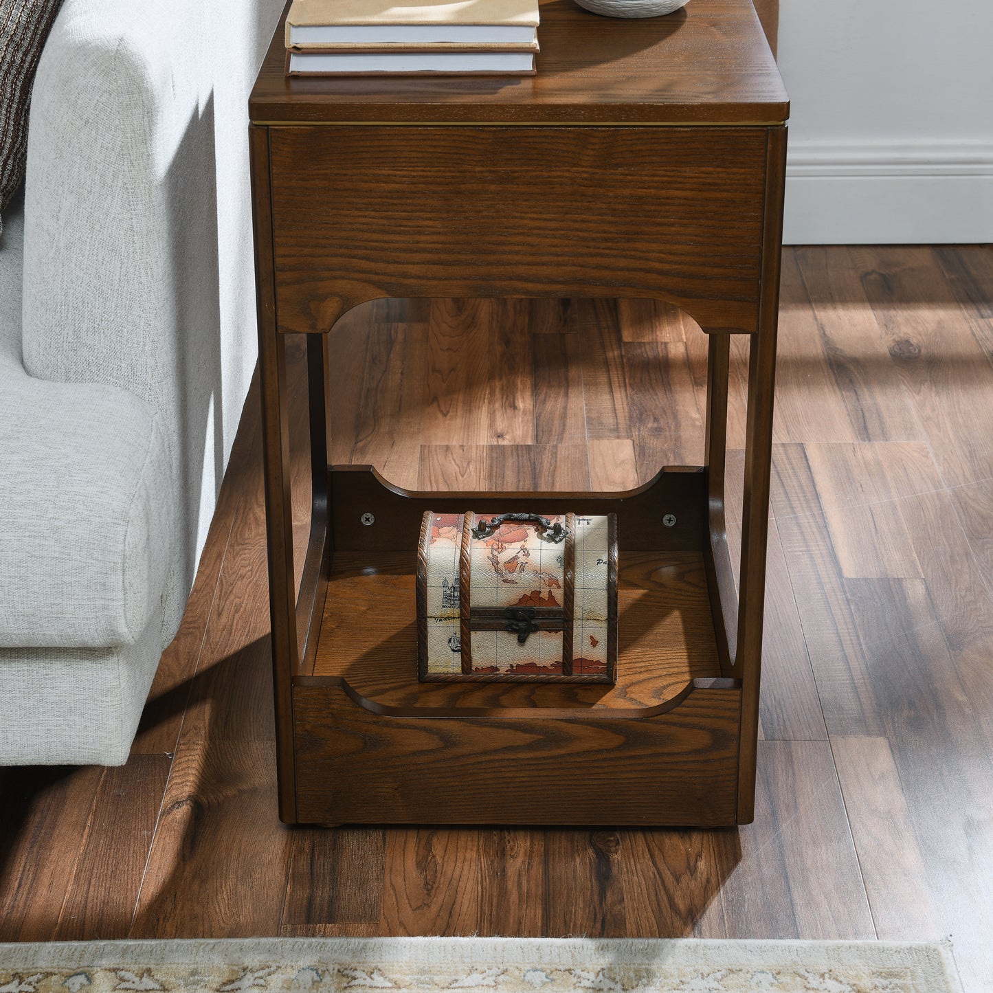 Rich oak wood accent table with a decorative antique map treasure chest on the lower shelf