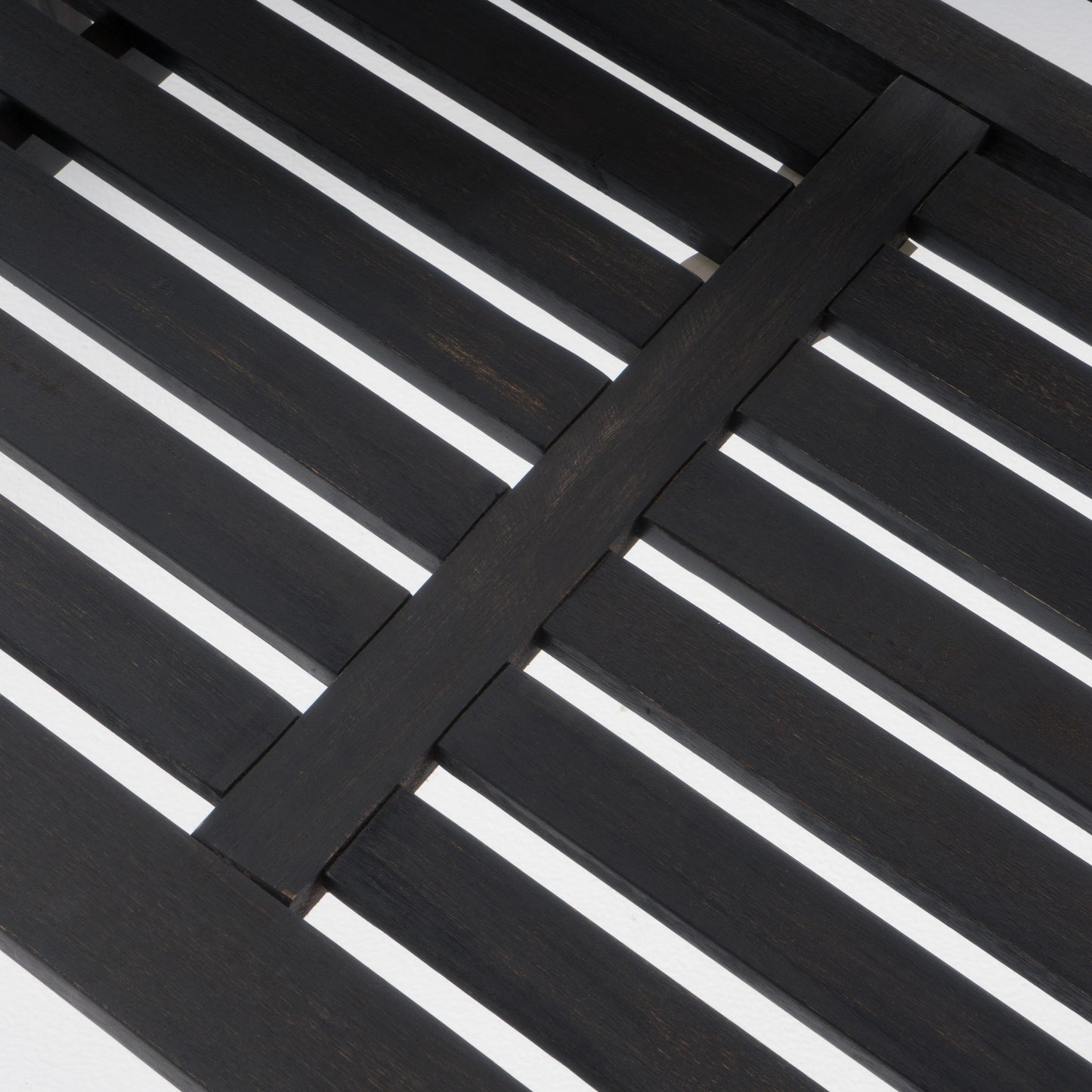 Dark wood slatted tabletop with intersecting planks