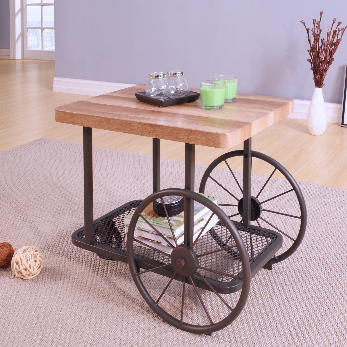 Rustic wood top coffee table with industrial wagon wheels and lower shelf for storage