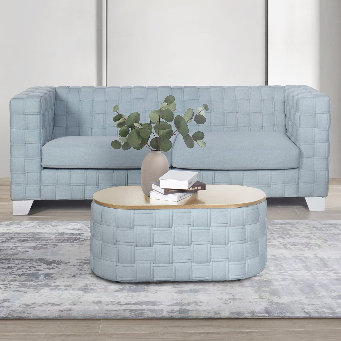 Pale blue woven fabric armchair with a textured finish and a modern design