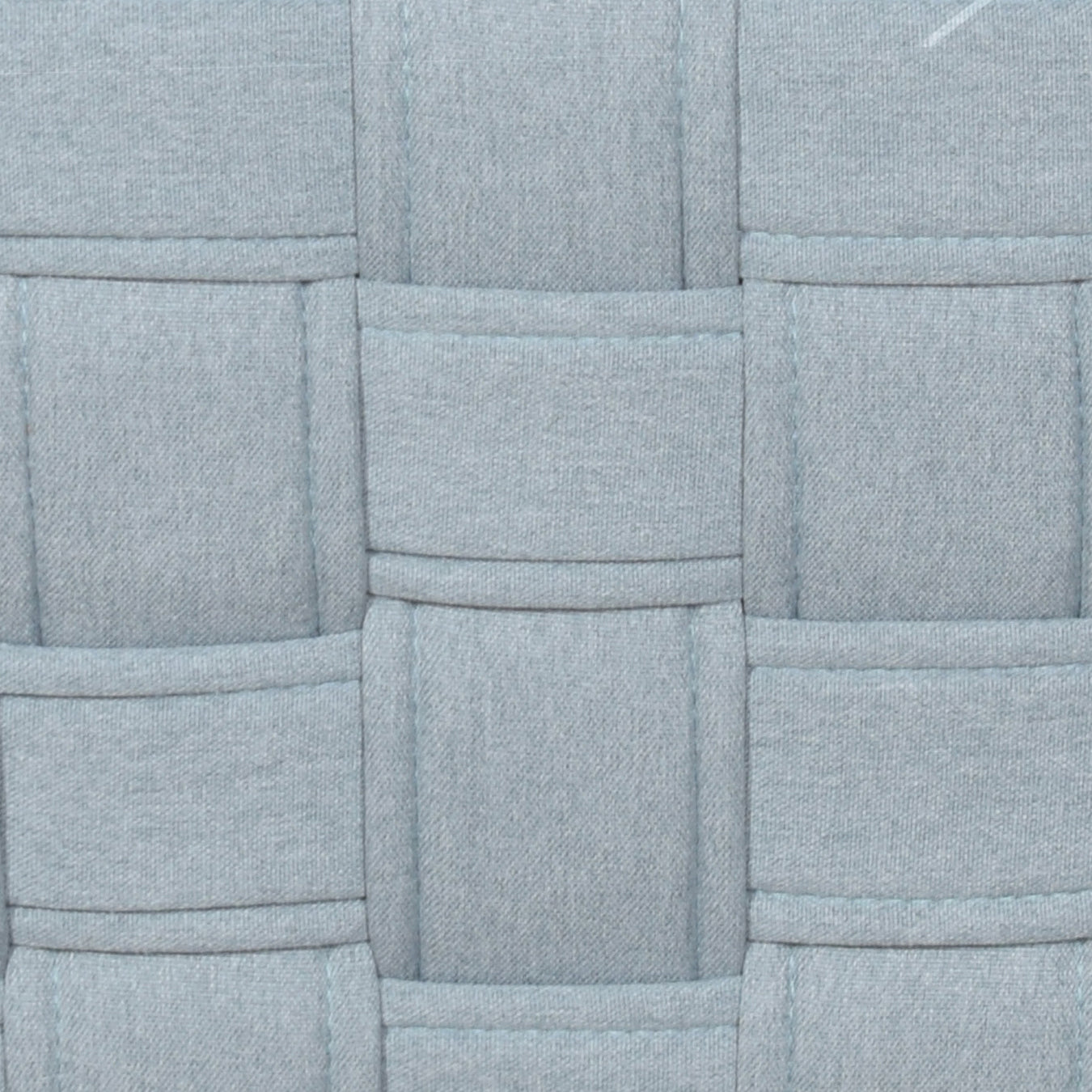 Closeup of pale blue woven fabric texture with stitched details