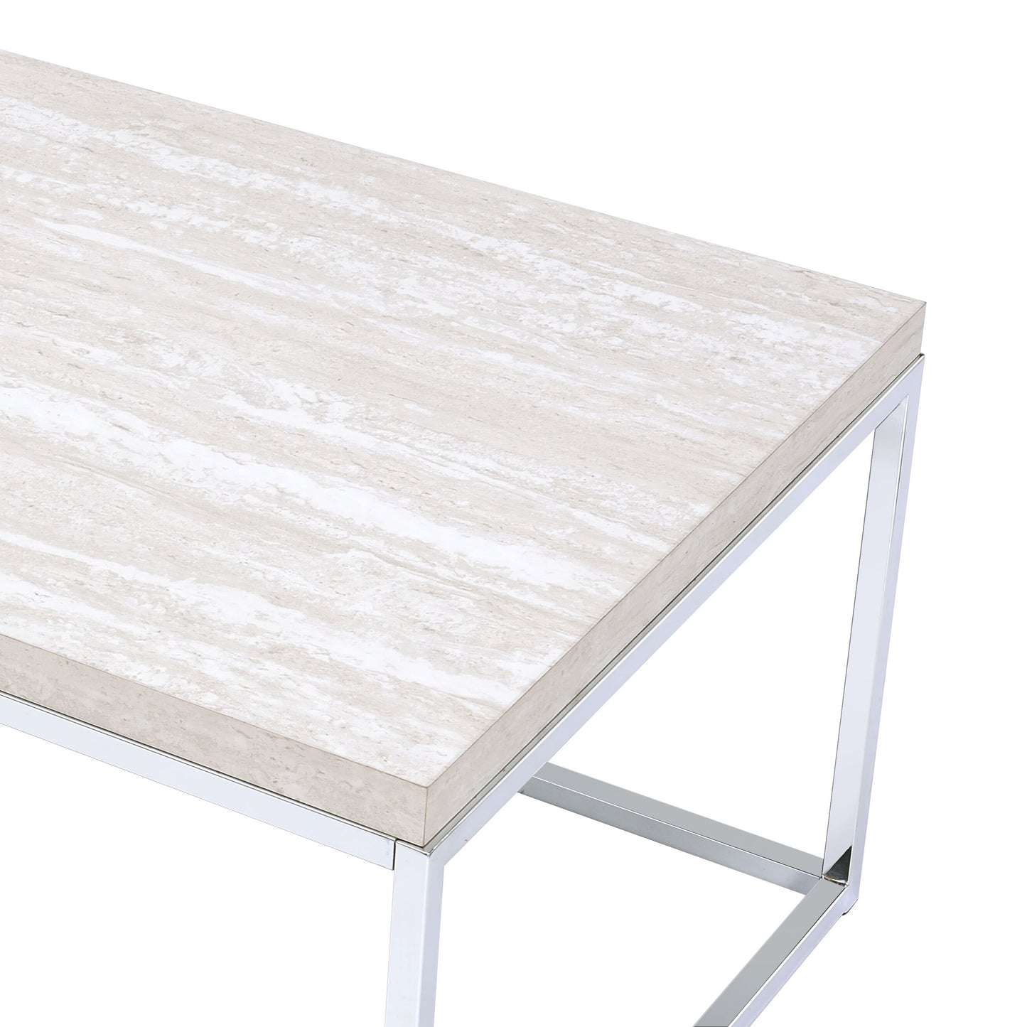 Closeup of a modern coffee table with a cream travertine marble top and polished chrome frame