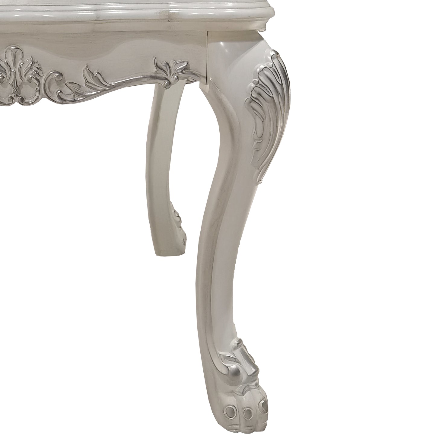 Ornate white carved table leg with silver accents