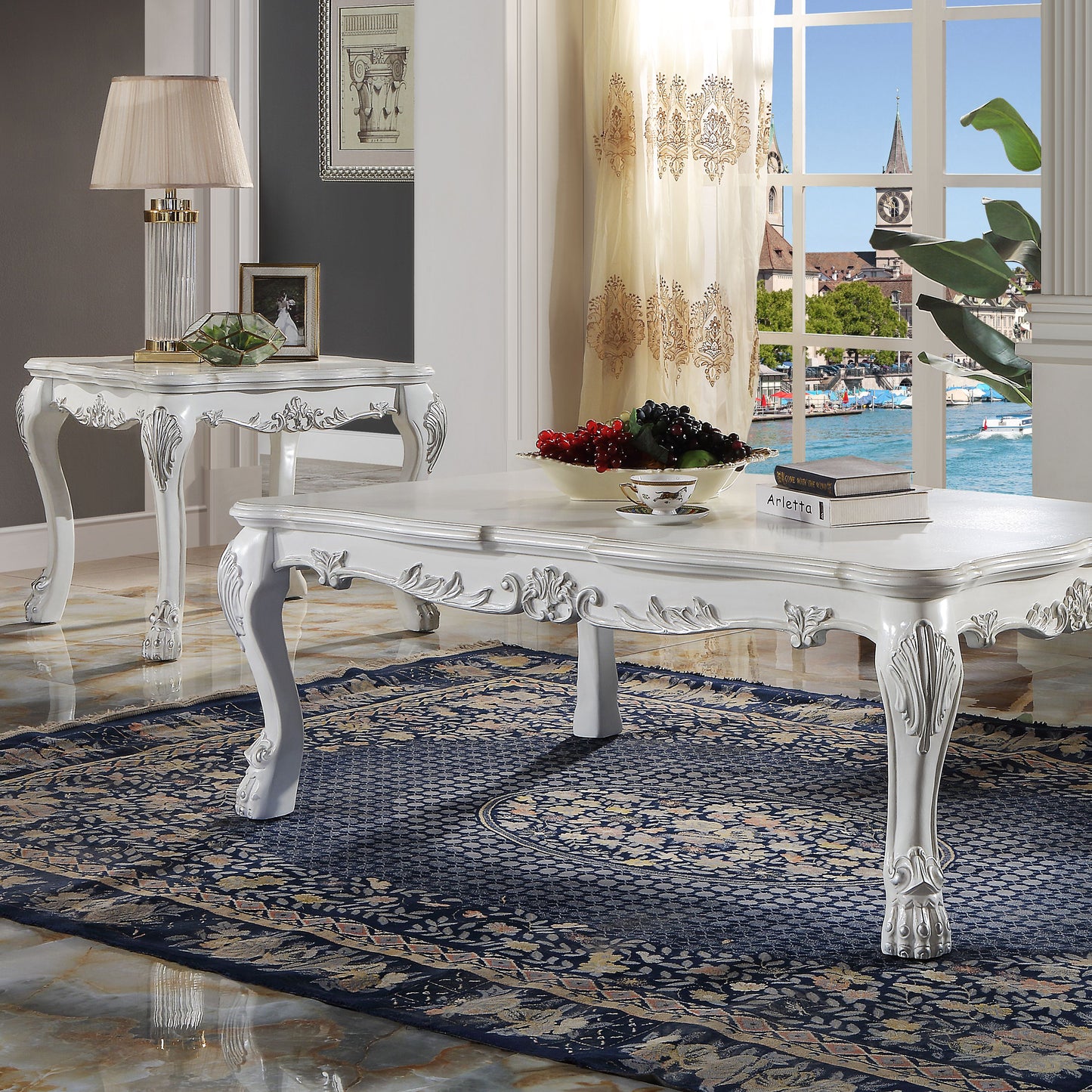 Ornate white wooden coffee table with carved legs on a patterned rug